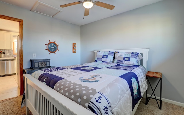 carpeted bedroom featuring ceiling fan, attic access, and baseboards