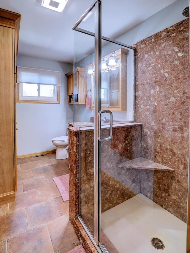 full bath featuring toilet and a stall shower