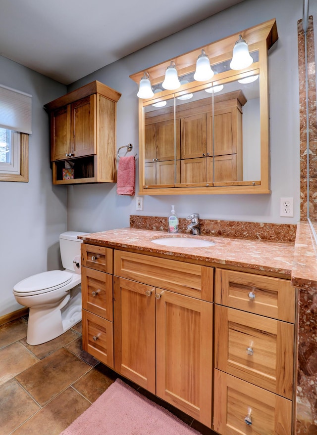 bathroom with tile patterned flooring, vanity, and toilet