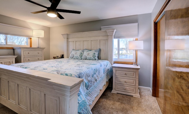 bedroom featuring baseboards, multiple windows, ceiling fan, and carpet flooring