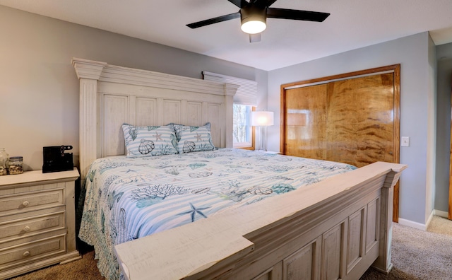 bedroom featuring baseboards, a closet, dark carpet, and a ceiling fan