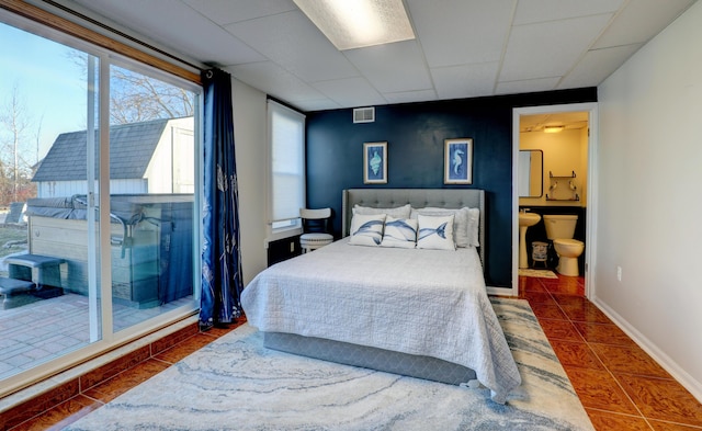 bedroom with baseboards, visible vents, a drop ceiling, tile patterned floors, and access to outside