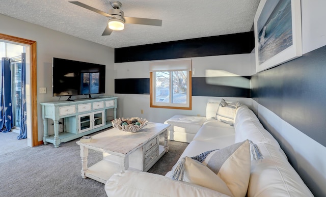 carpeted living area with ceiling fan and a textured ceiling