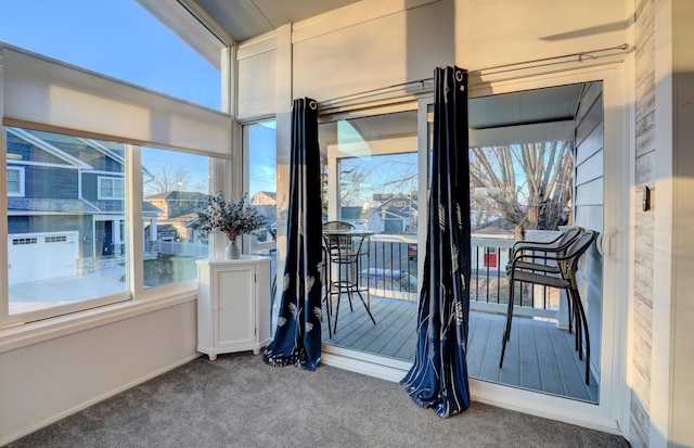 doorway to outside featuring carpet floors