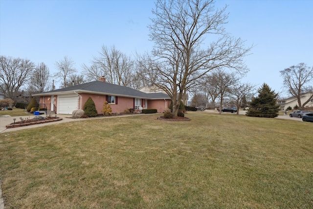 view of front of house featuring a garage, a front yard, brick siding, and a chimney