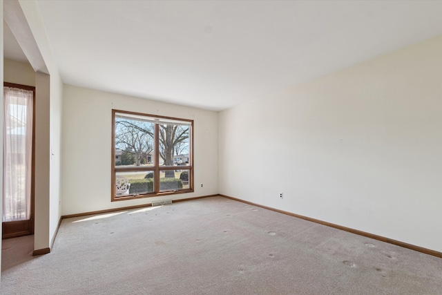 empty room with carpet and baseboards