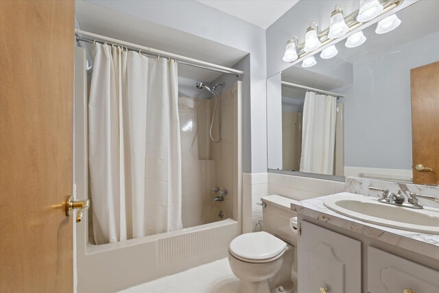 bathroom with toilet, shower / bathtub combination with curtain, and vanity