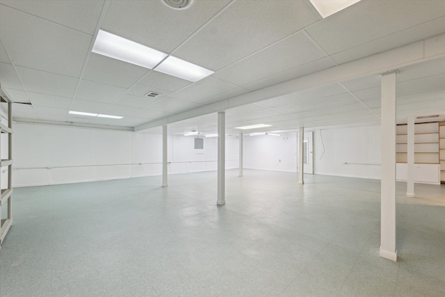 finished basement with a drop ceiling and tile patterned floors