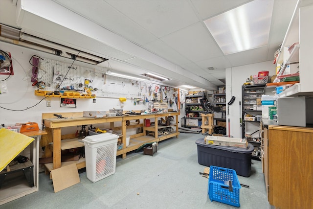 interior space with a drop ceiling and a workshop area