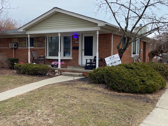 bungalow-style home featuring brick siding