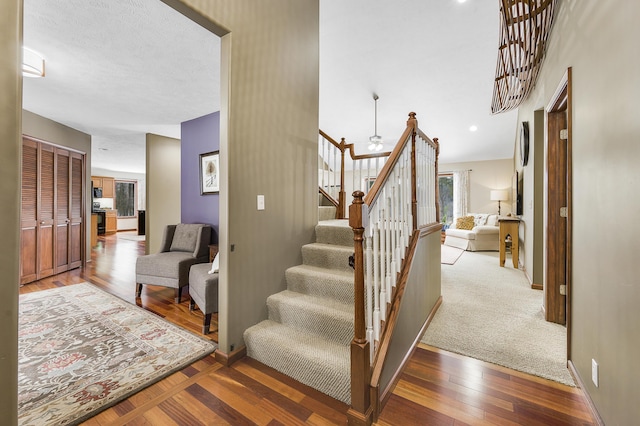 stairway with baseboards and wood finished floors