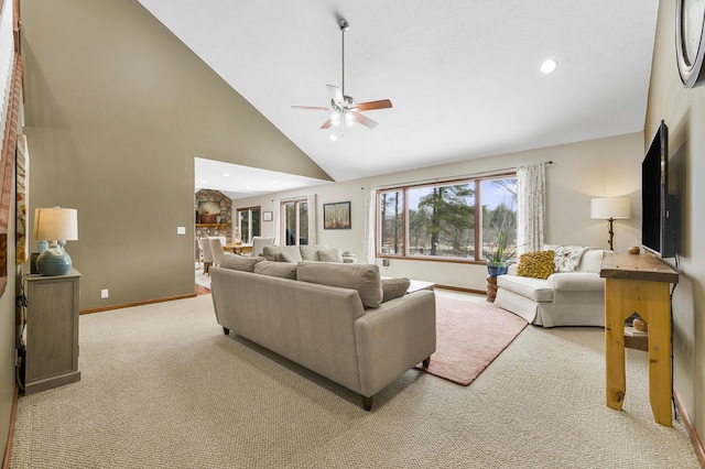 carpeted living area with high vaulted ceiling, recessed lighting, baseboards, and a ceiling fan