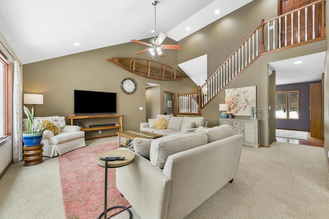 carpeted living area with ceiling fan, high vaulted ceiling, stairway, and recessed lighting