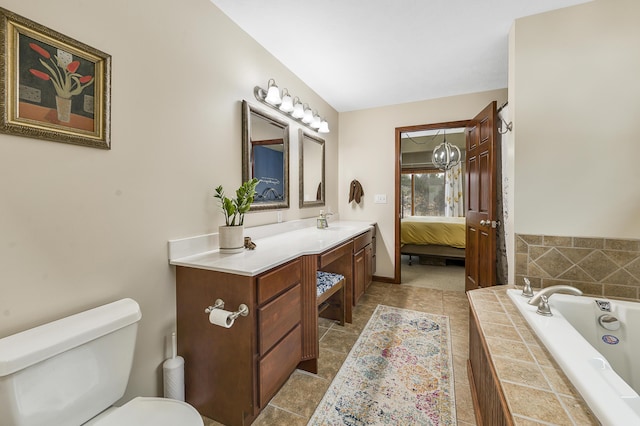 ensuite bathroom featuring baseboards, toilet, ensuite bathroom, a garden tub, and vanity