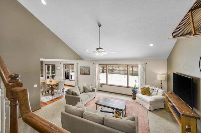 living area with baseboards, light colored carpet, ceiling fan, high vaulted ceiling, and recessed lighting