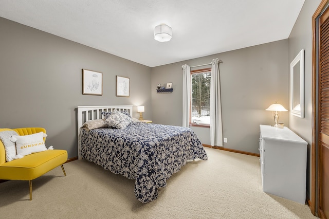 bedroom with light carpet and baseboards