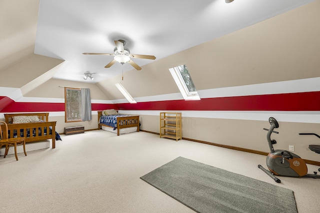 bedroom with lofted ceiling with skylight, carpet, multiple windows, and baseboards