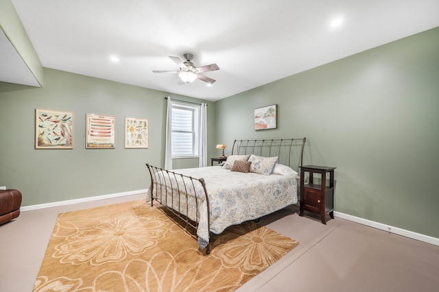 bedroom with concrete floors, a ceiling fan, and baseboards