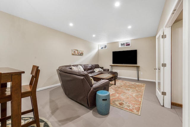 living room featuring baseboards and recessed lighting