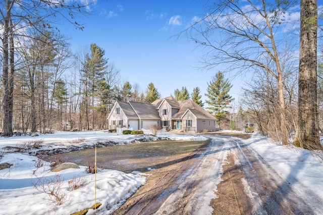 view of front of home featuring dirt driveway and an attached garage