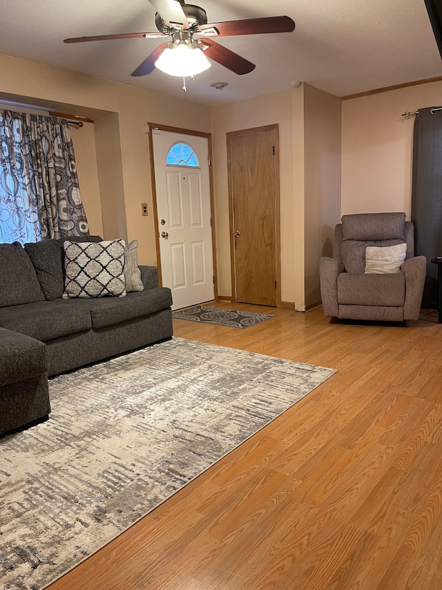 living room featuring light wood-style flooring and ceiling fan