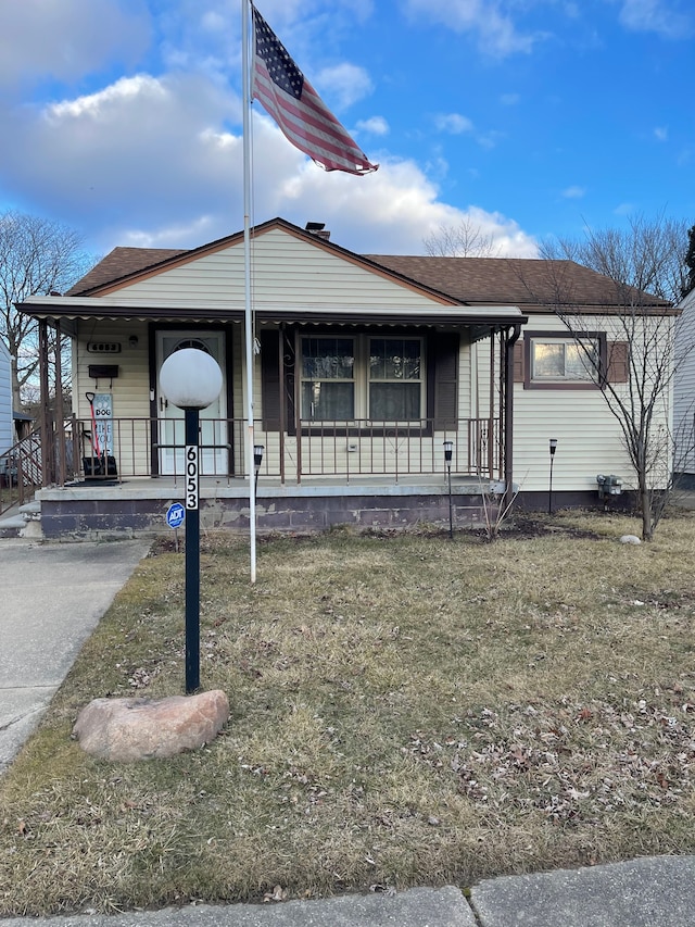 view of front of house with covered porch and a shingled roof