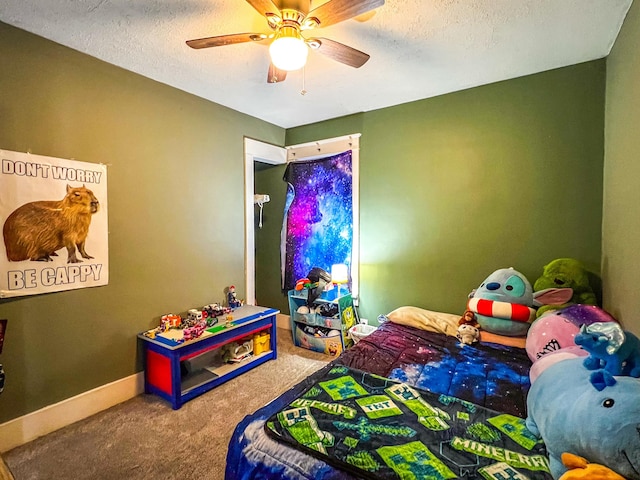 carpeted bedroom featuring a textured ceiling, ceiling fan, and baseboards