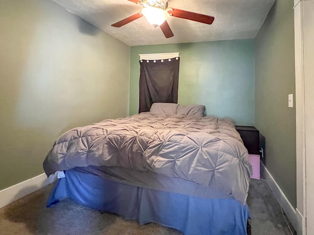 carpeted bedroom with ceiling fan and baseboards