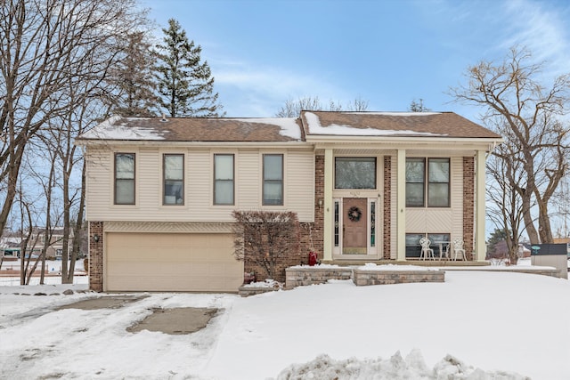 split foyer home with brick siding and an attached garage