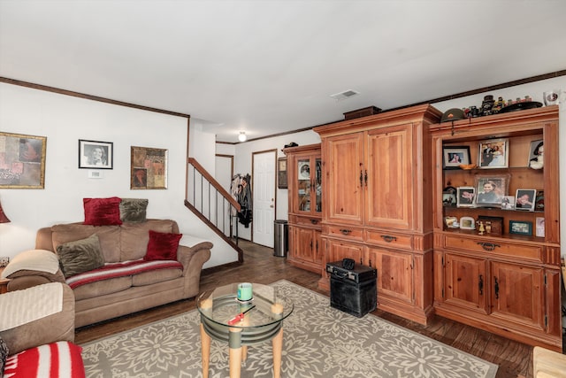 living area with stairs, wood finished floors, visible vents, and crown molding