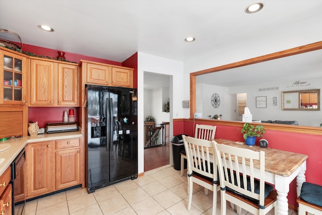 kitchen featuring light countertops, visible vents, black appliances, and light tile patterned floors