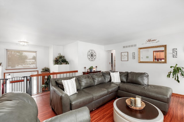 living room with visible vents and wood finished floors