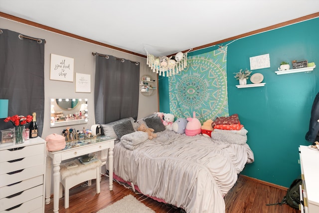 bedroom with baseboards and wood finished floors