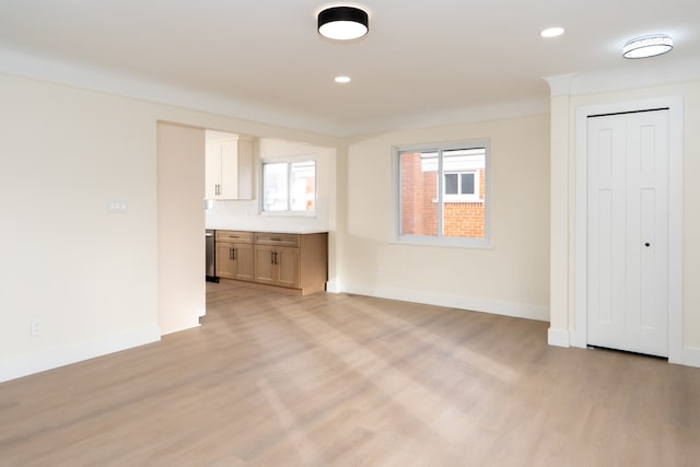 unfurnished living room featuring recessed lighting, baseboards, and light wood finished floors