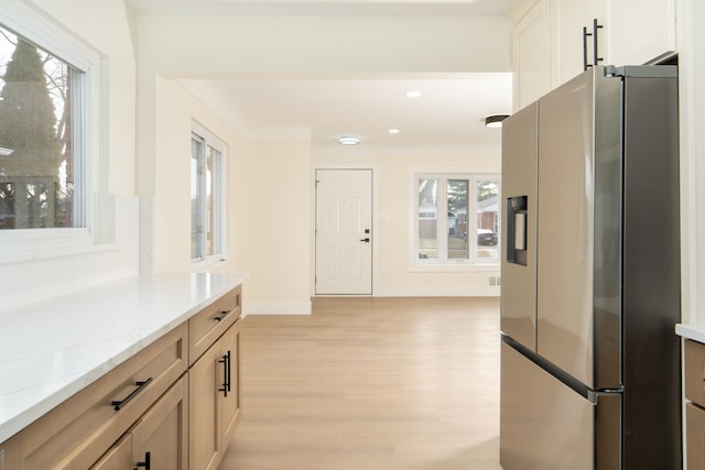 corridor featuring light wood finished floors, baseboards, and recessed lighting