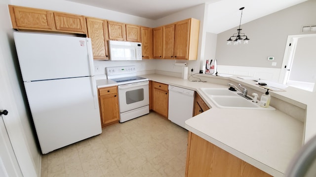 kitchen with a sink, white appliances, light countertops, lofted ceiling, and light floors