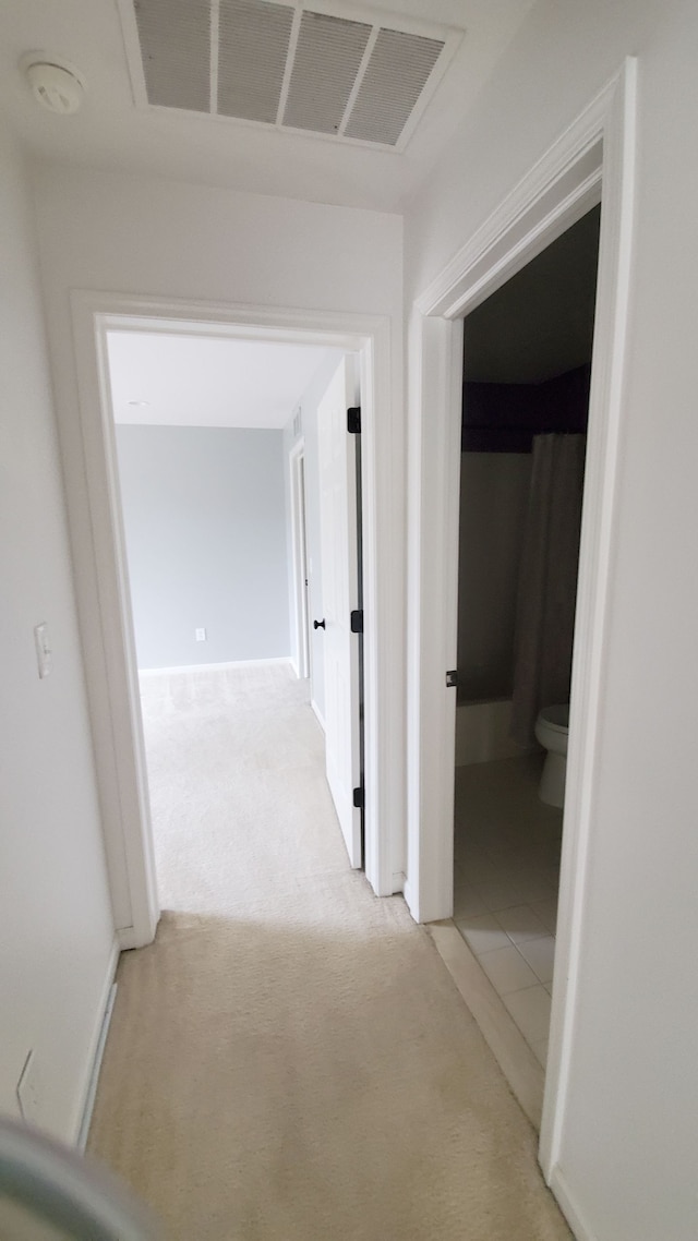 corridor with visible vents and light carpet