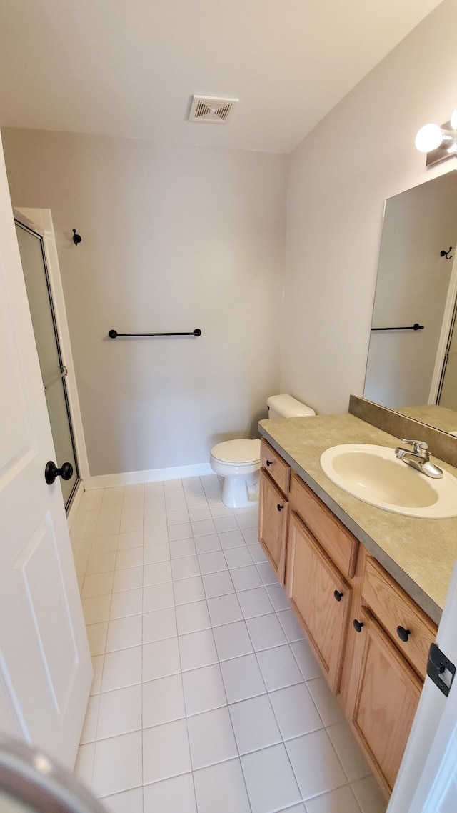 bathroom featuring tile patterned floors, visible vents, toilet, baseboards, and vanity