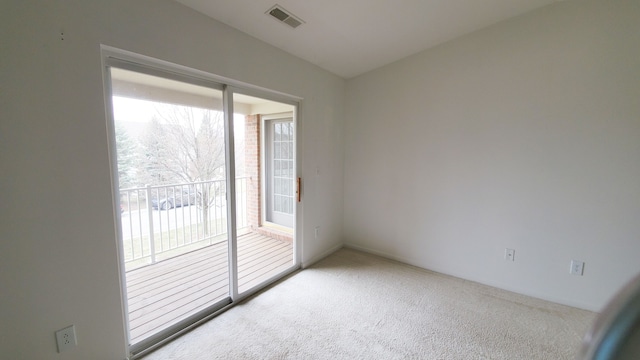 carpeted spare room with visible vents