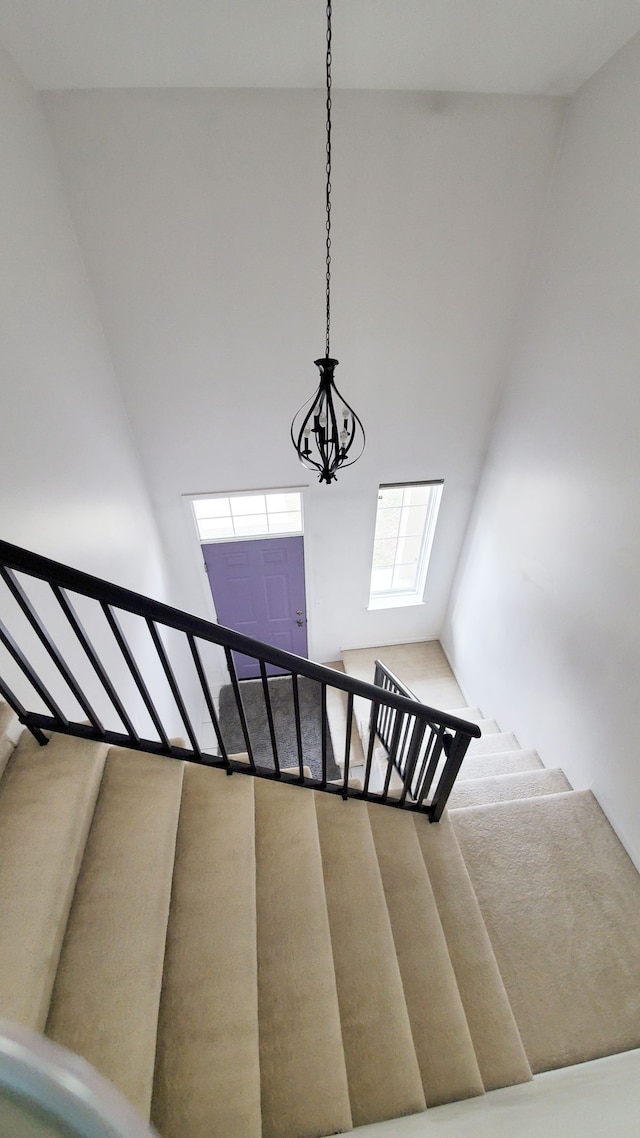 stairway featuring a high ceiling