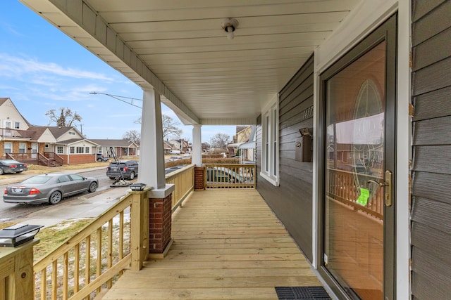 deck featuring a residential view and a porch