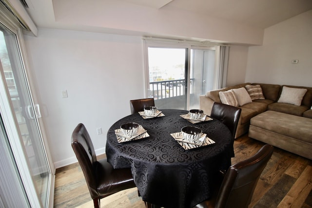 dining space featuring baseboards and wood finished floors