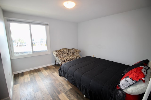 bedroom with baseboards and wood finished floors