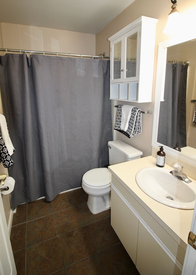 full bathroom with toilet, a shower with curtain, tile patterned flooring, and vanity