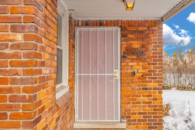 entrance to property featuring brick siding