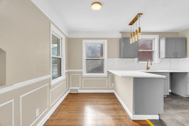 kitchen with gray cabinets, visible vents, and a healthy amount of sunlight