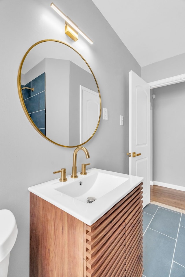 bathroom with vanity and baseboards