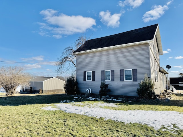 view of side of home featuring a yard