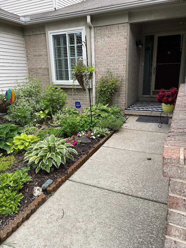 entrance to property featuring brick siding