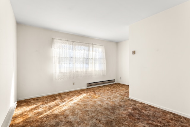 empty room featuring a baseboard heating unit, carpet floors, and baseboards